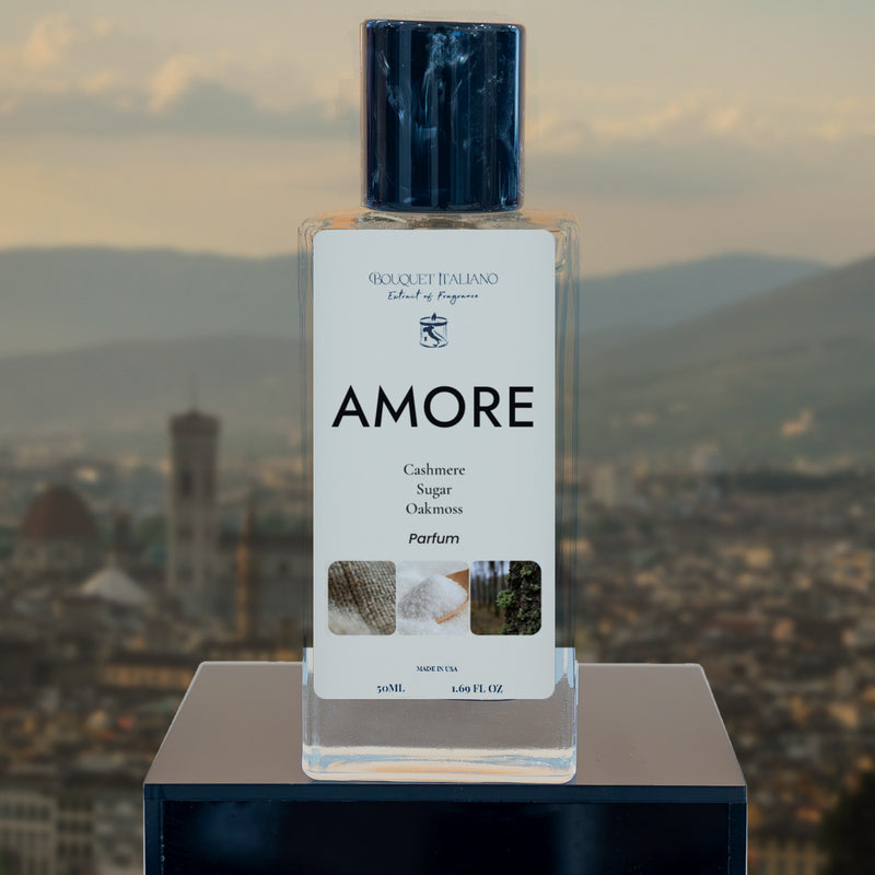 AMORE Luxury Travel Perfume 50 mL bottle on a black plinth, Florentine skyline at dusk behind