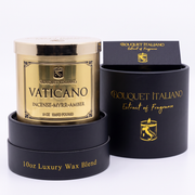 Vaticano Luxury Candle with its open black gift box on cream, studio still
